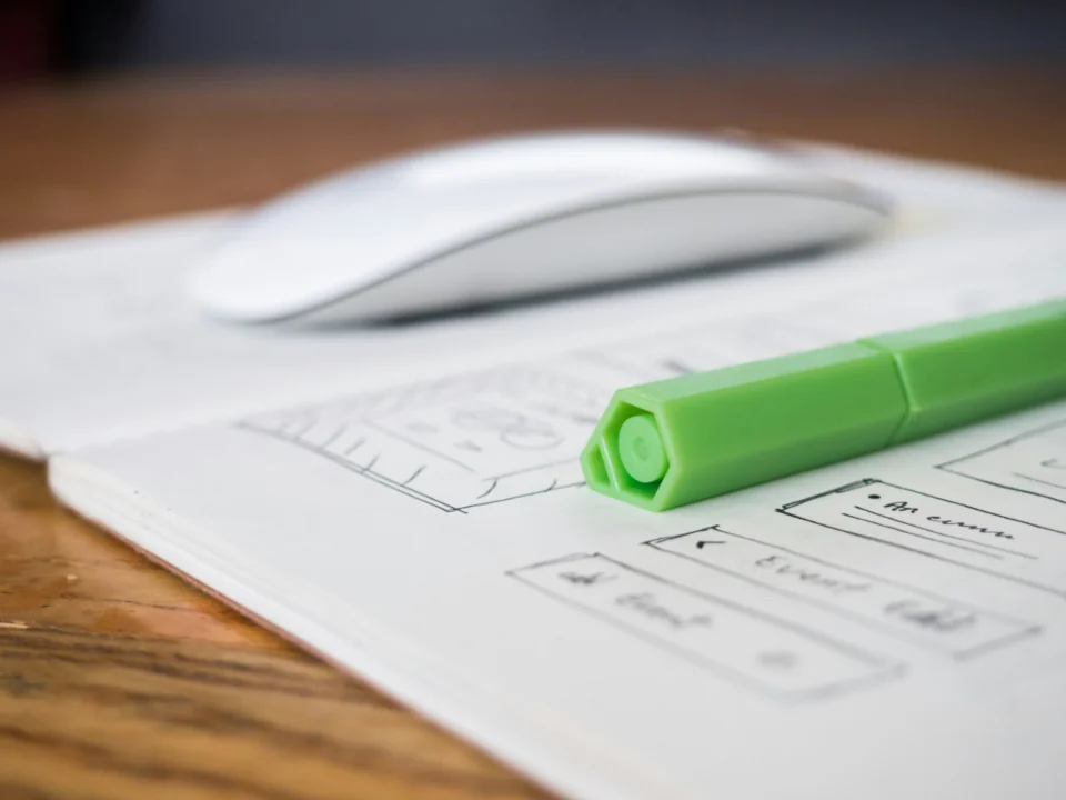 Desk with wireframe sketches and interface design process